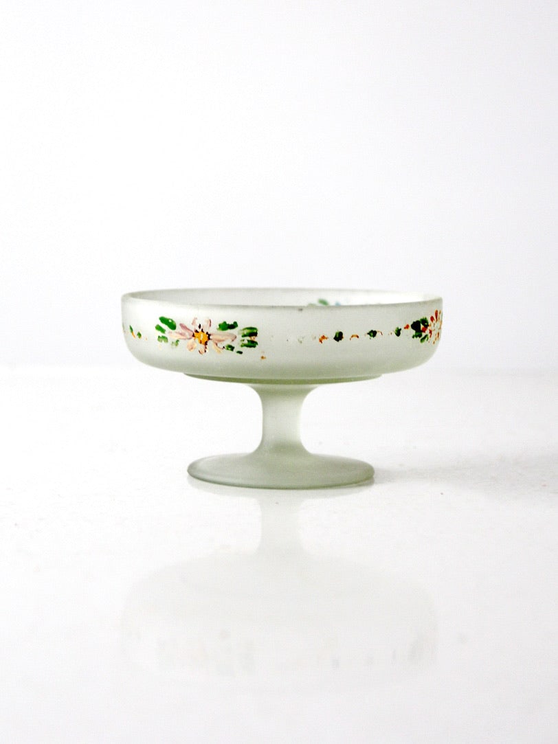 Hand Painted Satin Glass Compote with Floral Motif and Pedestal Base: Hand Painted Satin Glass Compote with Floral Motif and Pedestal Base This vintage satin glass compote dish features a softly frosted surface with a low pedestal foot and floral detailing around the ri