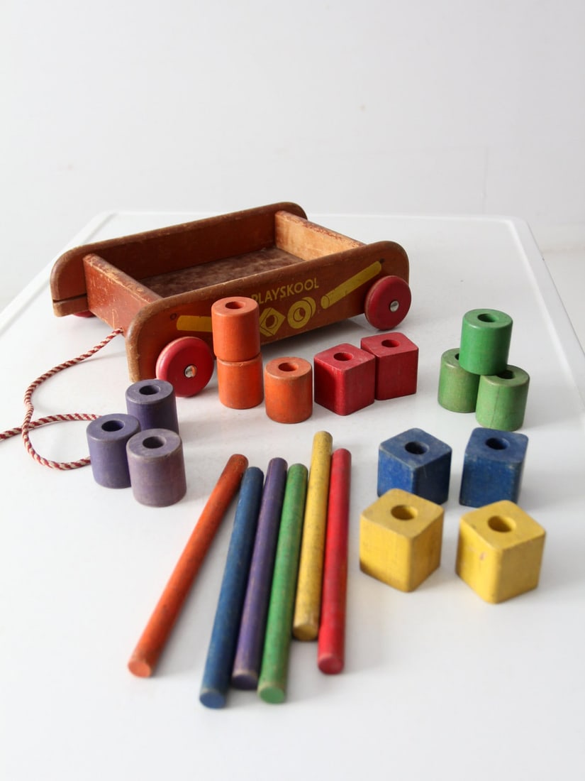 Vintage 1950s Playskool Wooden Toy Wagon with 21 Colorful Blocks: Vintage 1950s Playskool Wooden Toy Wagon with 21 Colorful Blocks Relive the charm of childhood with this vintage 1950s Playskool wooden toy wagon. This delightful piece comes complete with 21 colorful