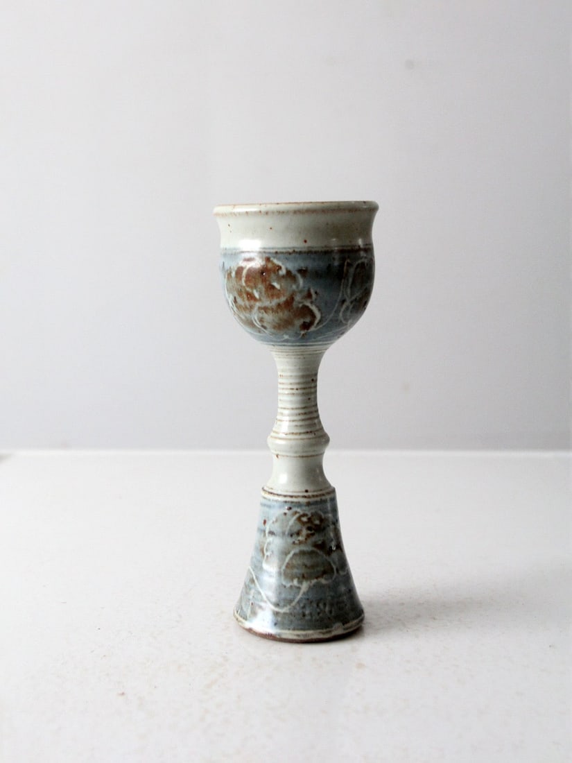 Handmade Vintage Pottery Chalice Signed Artist Ecru Blue Brown Glaze 9.25 In: Handmade Vintage Pottery Chalice Signed Artist Ecru Blue Brown Glaze 9.25 In This vintage studio pottery chalice is a beautiful handmade piece signed by the artist. It showcases an ethereal design, en