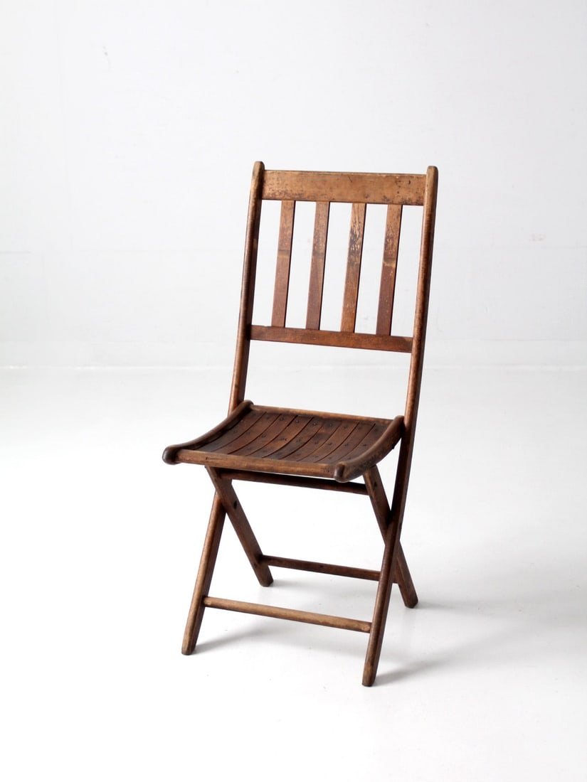 Pair of Vintage Wood Slat Folding Chairs Early 20th Century: Pair of Vintage Wood Slat Folding Chairs Early 20th Century Enhance your space with this pair of vintage wood slat folding chairs from the early 20th century. Crafted with a warm patinated slat wood,
