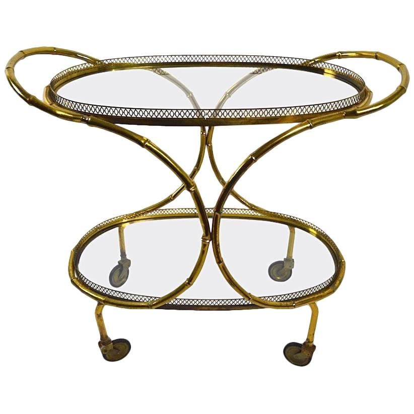 Chic Faux Bamboo Brass and Glass Serving Cart Trolley: Chic Faux Bamboo Brass and Glass Serving Cart Trolley Elevate your entertaining experience with this chic and stylish Faux Bamboo Serving Cart. Featuring a brass structure with plate glass trays, this