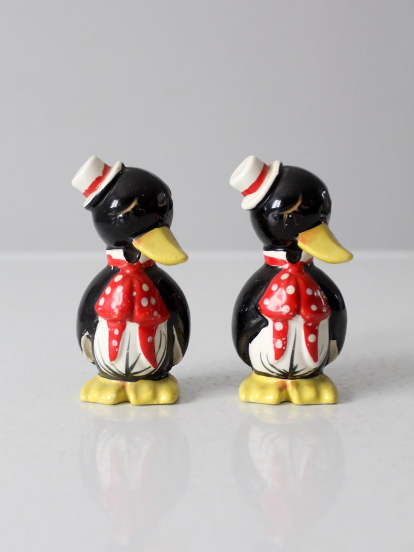 Vintage Mid-Century Ceramic Penguin Salt and Pepper Shakers: Vintage Mid-Century Ceramic Penguin Salt and Pepper Shakers Add a touch of whimsy to your dining experience with this charming vintage mid-century penguin salt and pepper shaker set from Japan. Crafte