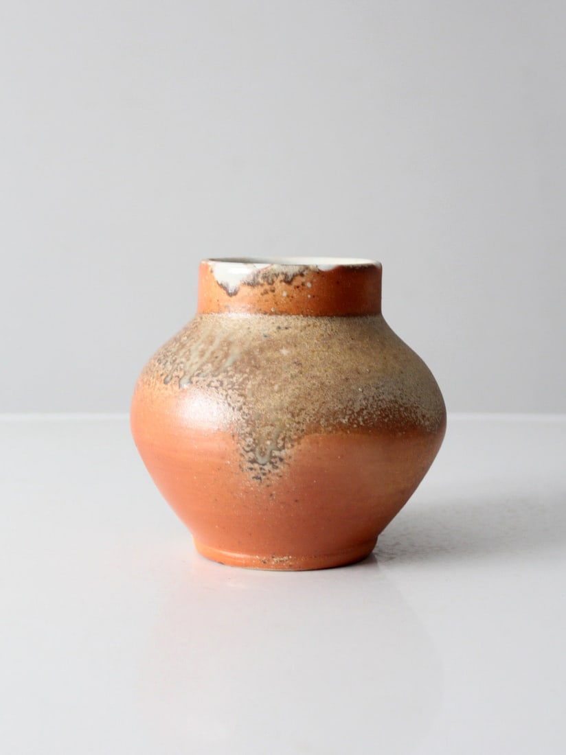 Rounded Earth Tone Ceramic Vase Handmade Vintage Studio Accent: Rounded Earth Tone Ceramic Vase Handmade Vintage Studio Accent This vintage handmade studio pottery vase showcases a rounded silhouette with warm, earthy tones and subtle tonal variations across the s