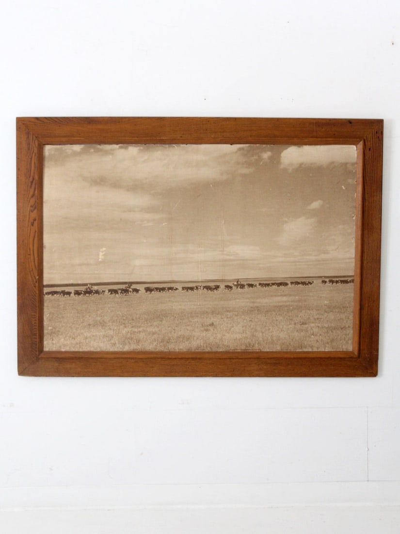 Vintage Western Landscape Photo Cowboy Herd in Wood Frame: Vintage Western Landscape Photo Cowboy Herd in Wood Frame This vintage American West landscape photo captures a cowboy herd roundup from the early 20th century. The grand sepia print is presented in a