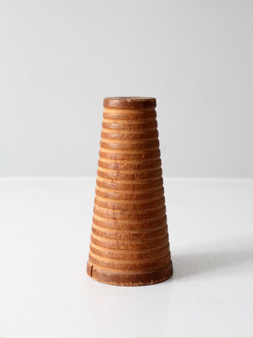 Vintage Canadian Wooden Textile Spool 7 inches Primitive Decor: Vintage Canadian Wooden Textile Spool 7 inches Primitive Decor This vintage Canadian wooden textile spool showcases a tapered design, marked with 'Made in Canada.' Its crisp ribbing and soft, honeyed