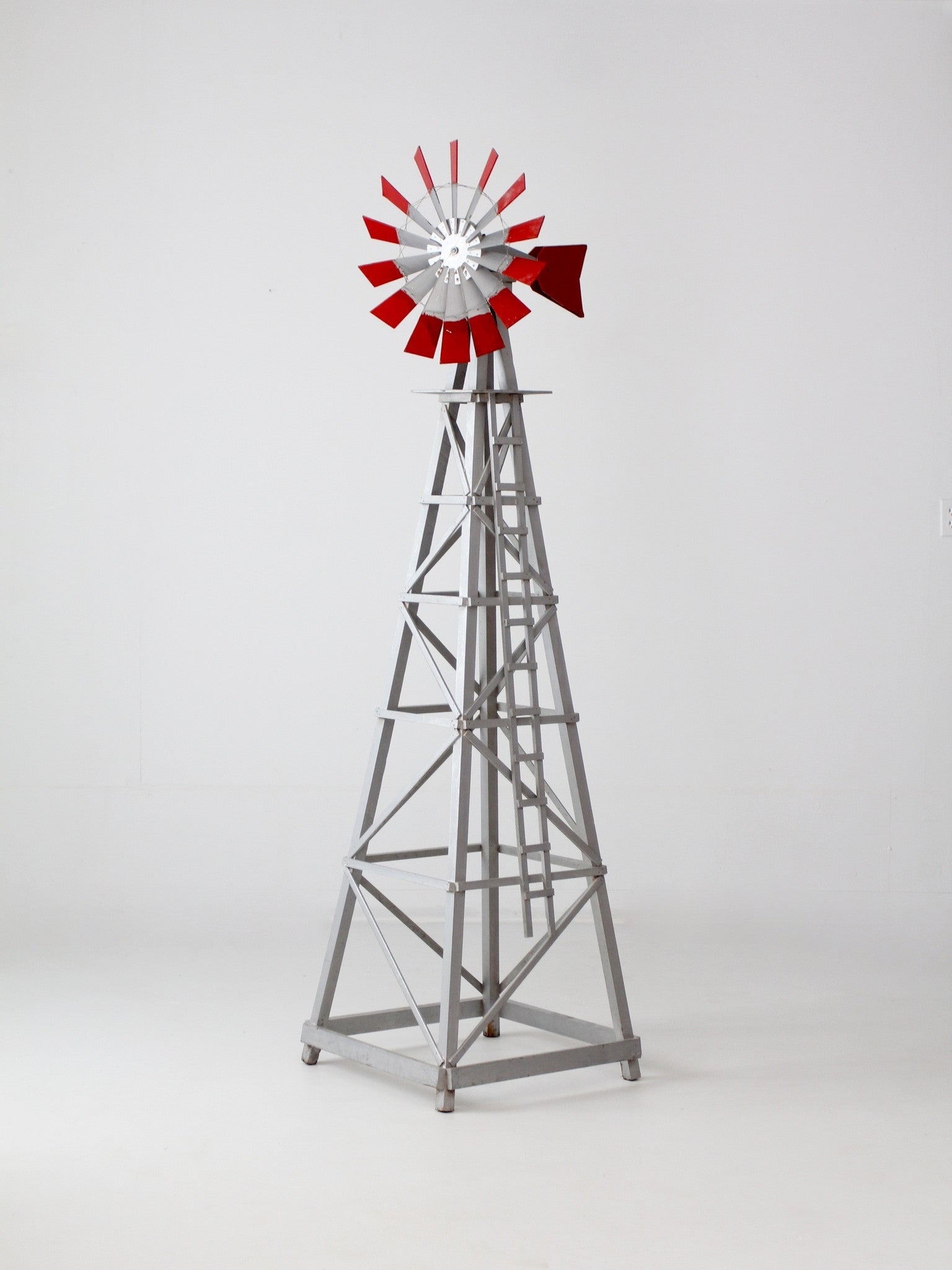 Charming Vintage Gray Wood Garden Windmill with Red Stripes: Charming Vintage Gray Wood Garden Windmill with Red Stripes Enhance your garden decor with this vintage decorative windmill. Crafted from tall gray wood, this charming piece features striking red stri