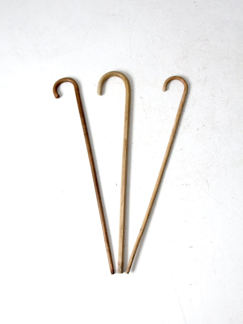 Rustic Vintage Wooden Canes Set of 3 with Tapered Ends: Rustic Vintage Wooden Canes Set of 3 with Tapered Ends This set of three vintage wooden canes features rustic, burled wood construction with tapered ends and rounded handles. Each cane is finished wit