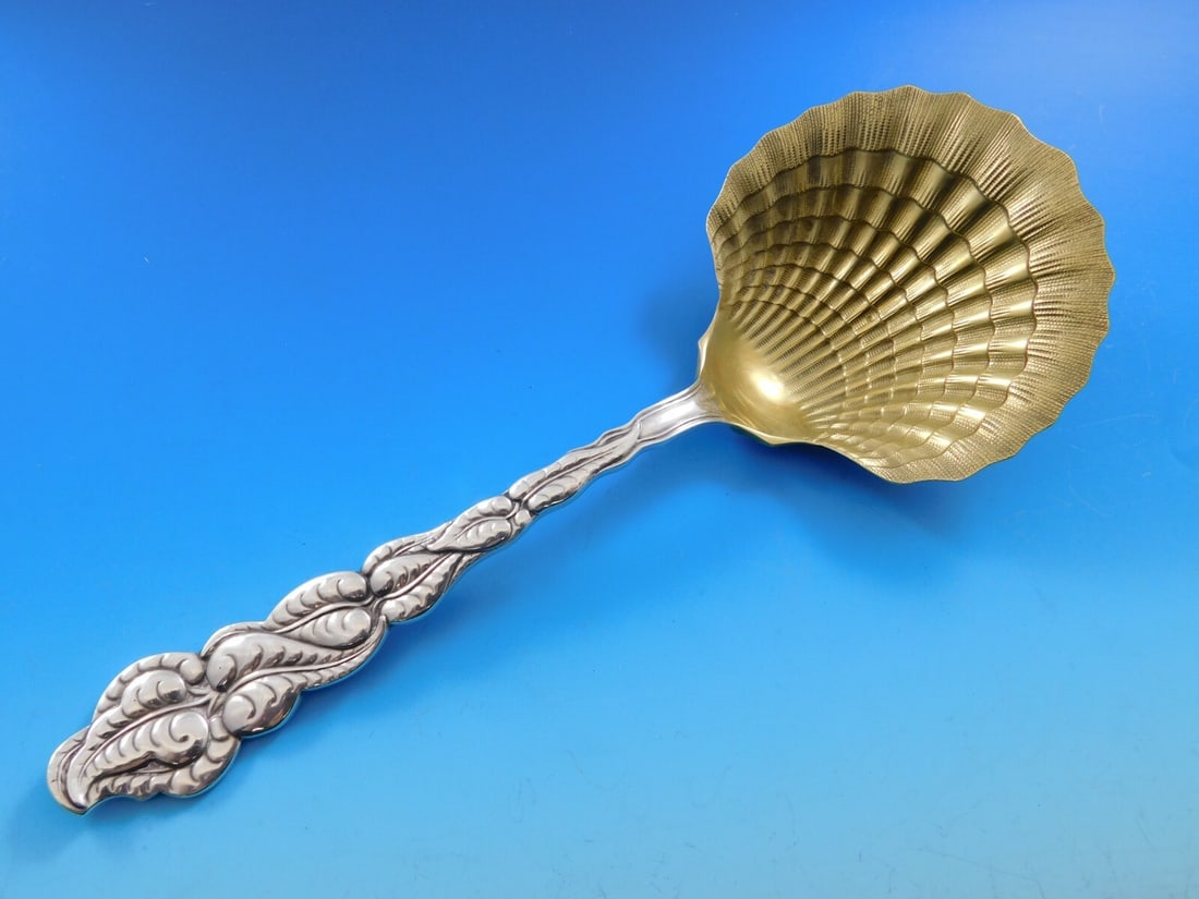 Tiffany & Co Ailanthus Sterling Silver Berry Spoon Gold Washed 8 7/8": Tiffany & Co Ailanthus Sterling Silver Berry Spoon Gold Washed 8 7/8" This exquisite Ailanthus serving spoon by Tiffany & Co. is crafted from sterling silver and features a stunning gold-washed clam s