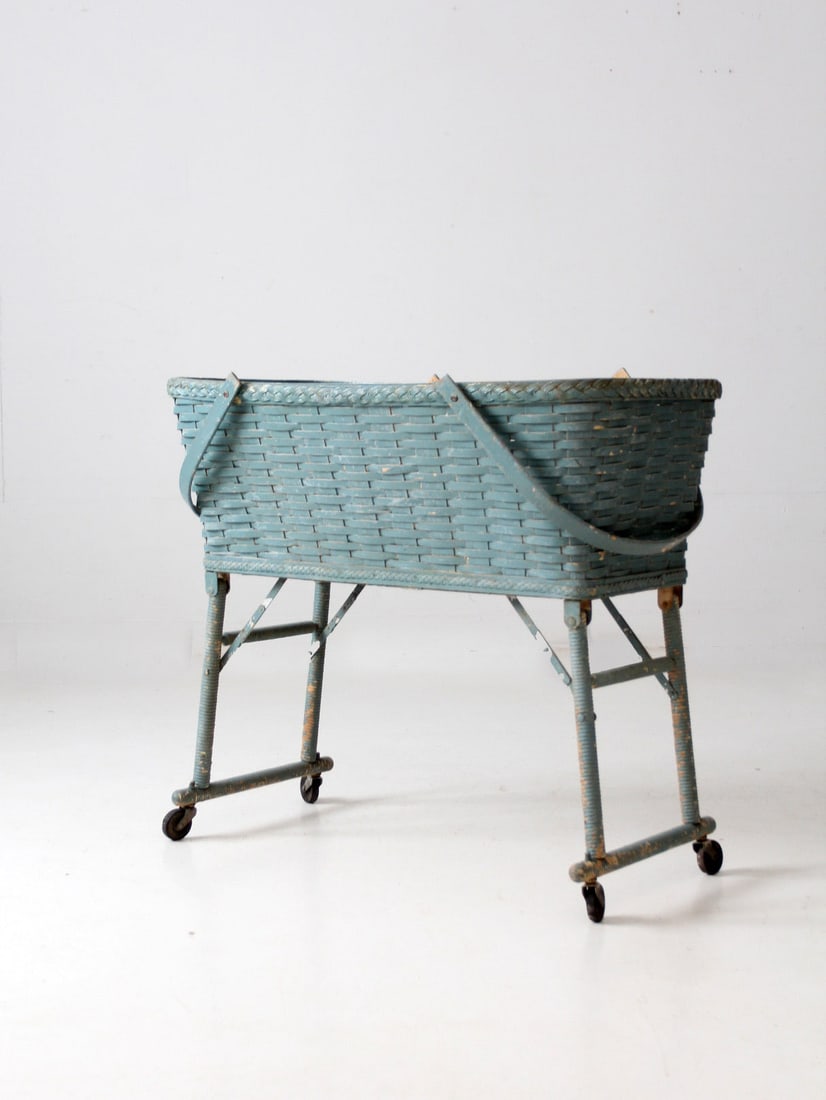 Antique Blue Woven Basket with Wooden Handles and Casters: Antique Blue Woven Basket with Wooden Handles and Casters Discover the charm of this antique woven basket, perfect for a variety of uses. With its playful blue color, this basket features sturdy woode