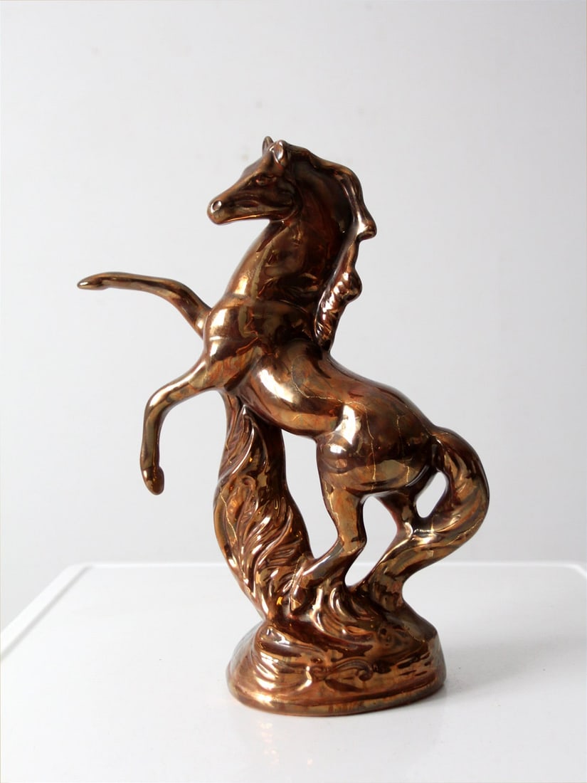 Mid-Century Metallic Glaze Ceramic Horse Sculpture: Mid-Century Metallic Glaze Ceramic Horse Sculpture This exquisite mid-20th-century ceramic horse sculpture showcases a dynamic rearing form, finished in a lustrous metallic glaze that features warm br