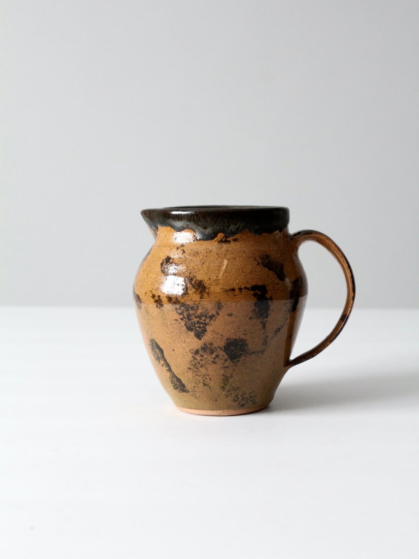 Signed Vintage Studio Pottery Pitcher Ceramic Ewer 1992: Signed Vintage Studio Pottery Pitcher Ceramic Ewer 1992 This vintage studio pottery pitcher is a beautifully hand-crafted ceramic ewer that showcases a striking black and tan glaze with a unique splas