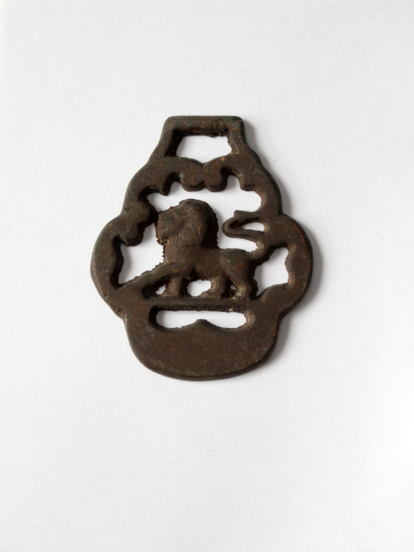 Antique Brass Equestrian Chest Emblem with Lion and Shield Design: Antique Brass Equestrian Chest Emblem with Lion and Shield Design This antique brass equestrian chest harness emblem showcases a beautifully intricate lion and shield design, embodying historical char