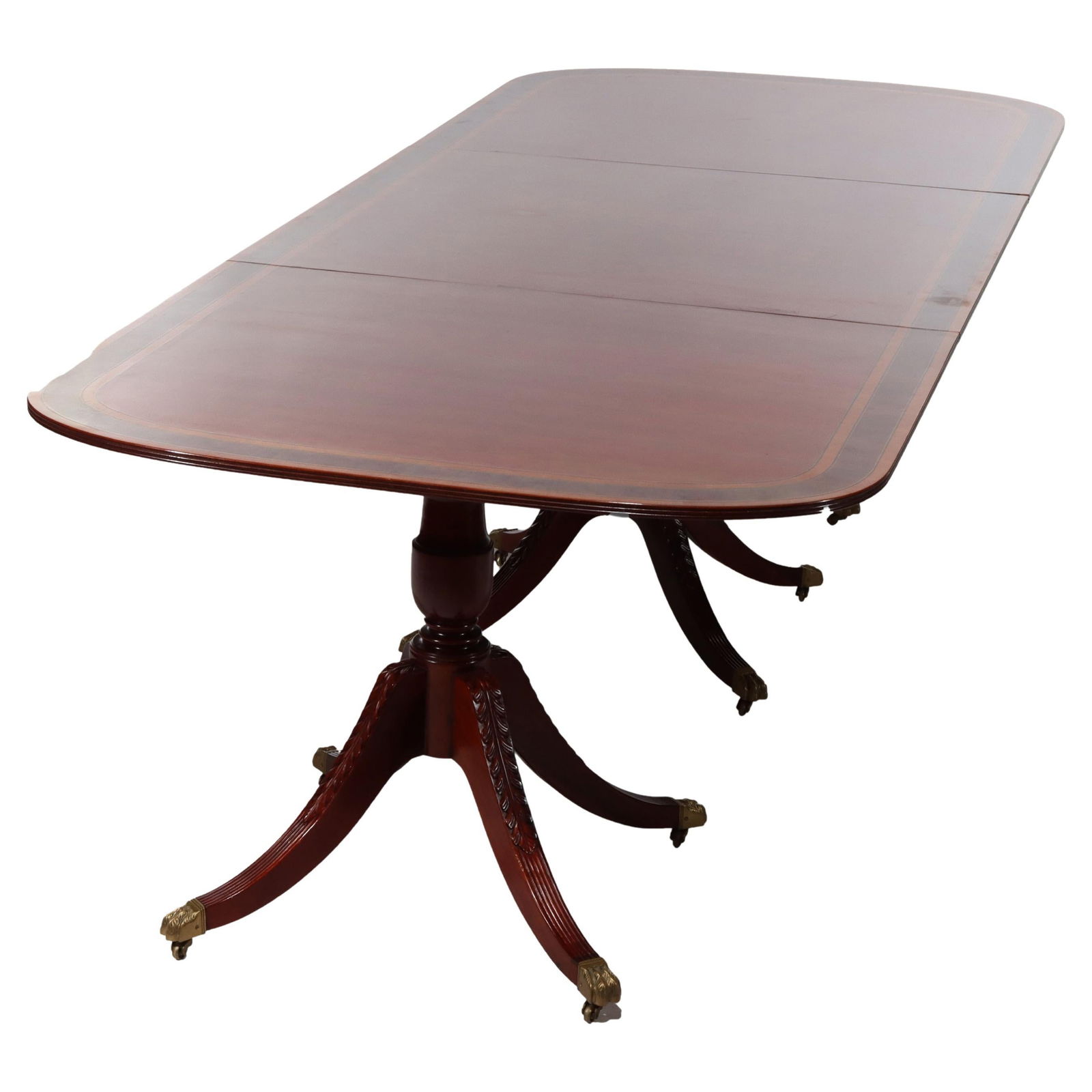 20th Century Carved Mahogany Triple Pedestal Conference Dining Table: 20th Century Carved Mahogany Triple Pedestal Conference Dining Table This impressive 13-foot conference dining table features a stunning carved mahogany design with a triple pedestal base. Its extensi