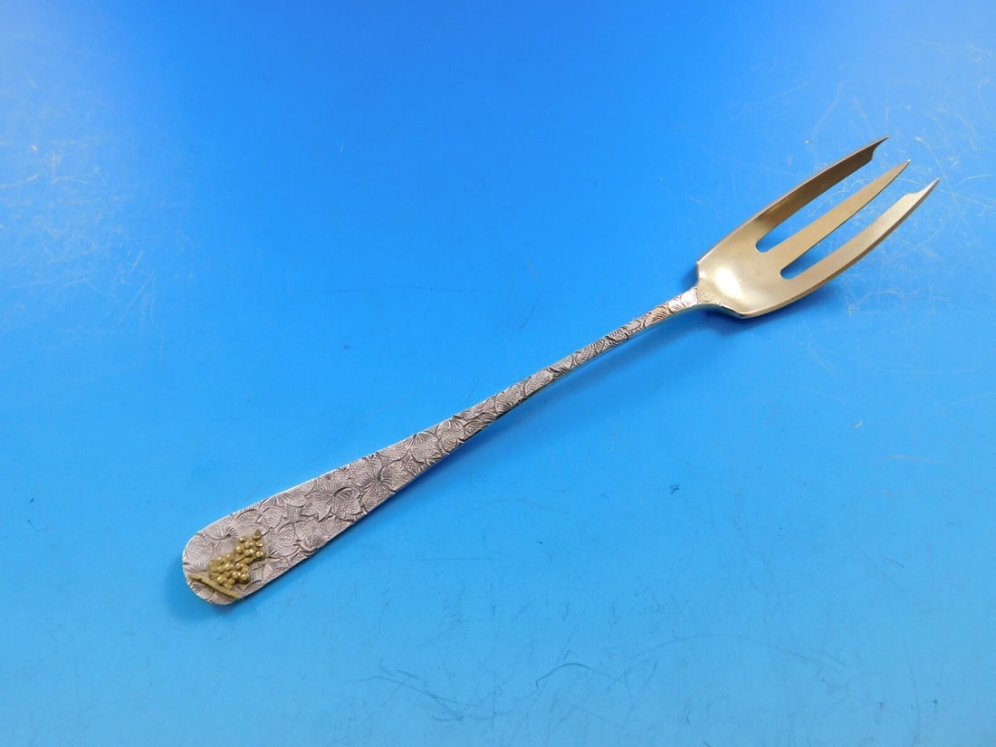 Dominick & Haff Sterling Silver Cocktail Fork Gold Grapes 3 7/8": Dominick & Haff Sterling Silver Cocktail Fork Gold Grapes 3 7/8" This exquisite cocktail fork, crafted by Dominick & Haff, showcases a stunning hammered and applied design. Made of sterling silver, it