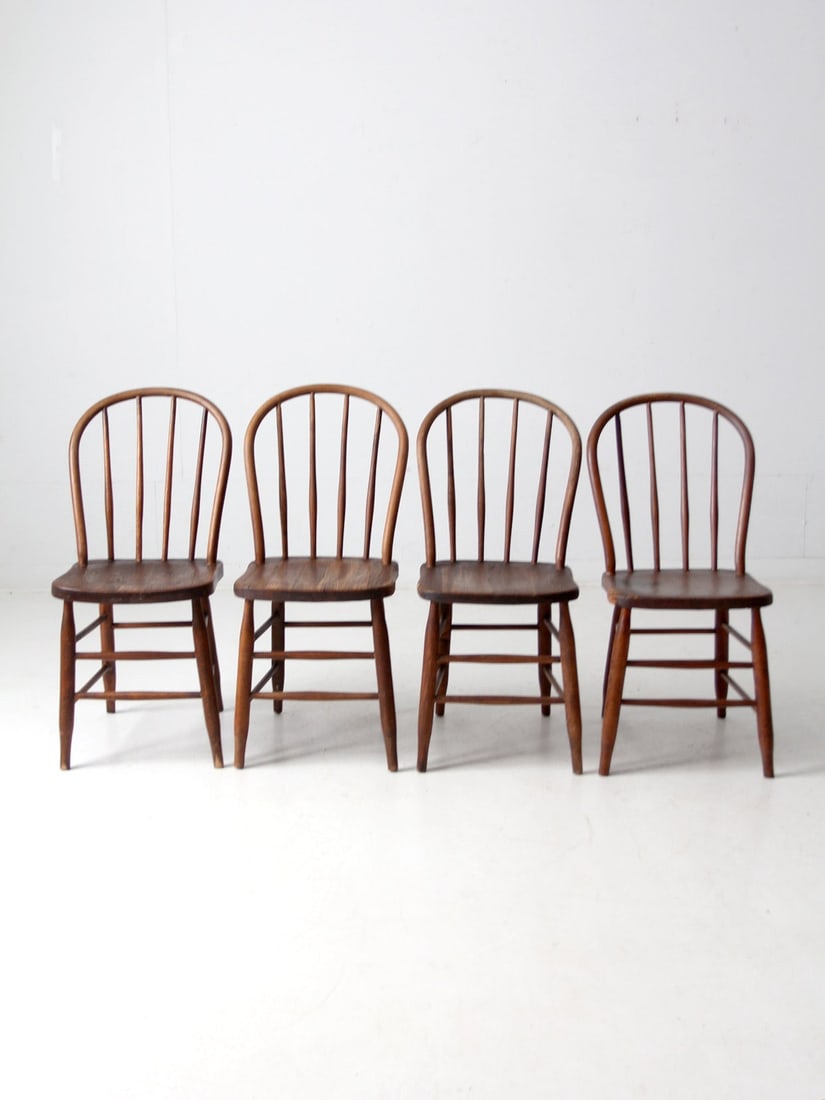 Set of 4 Antique Windsor Spindle Back Farmhouse Chairs: Set of 4 Antique Windsor Spindle Back Farmhouse Chairs Enhance your dining area with this charming set of four early 20th-century Windsor farmhouse chairs. Each chair showcases slender spindles, elega
