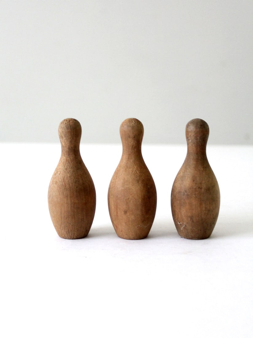 Vintage Handcrafted Wood Skittles Set of 3 Tabletop Bowling Pins: Vintage Handcrafted Wood Skittles Set of 3 Tabletop Bowling Pins Introduce a delightful vintage flair to your decor with this set of three handcrafted wooden skittles. Featuring smooth curves and a we