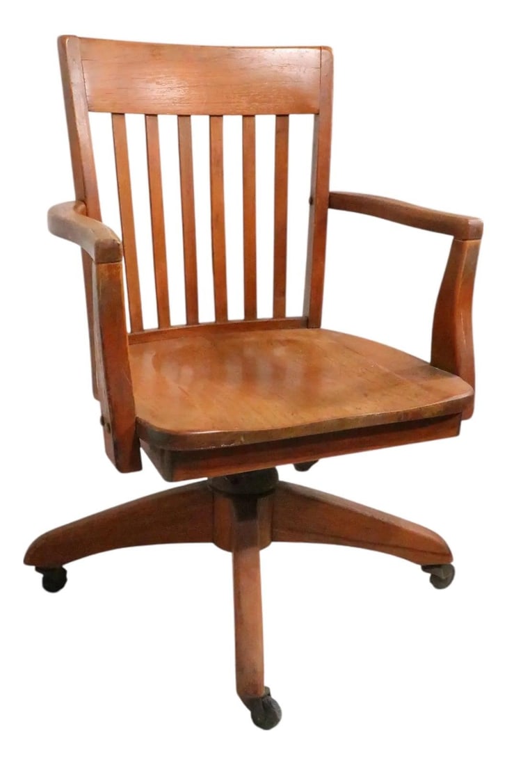 Adjustable Oak Desk Chair Inspired by Bank of England Jury Style: Adjustable Oak Desk Chair Inspired by Bank of England Jury Style This antique Bank of England style desk chair features an adjustable swivel and tilt mechanism, crafted from oak with a classic brown f