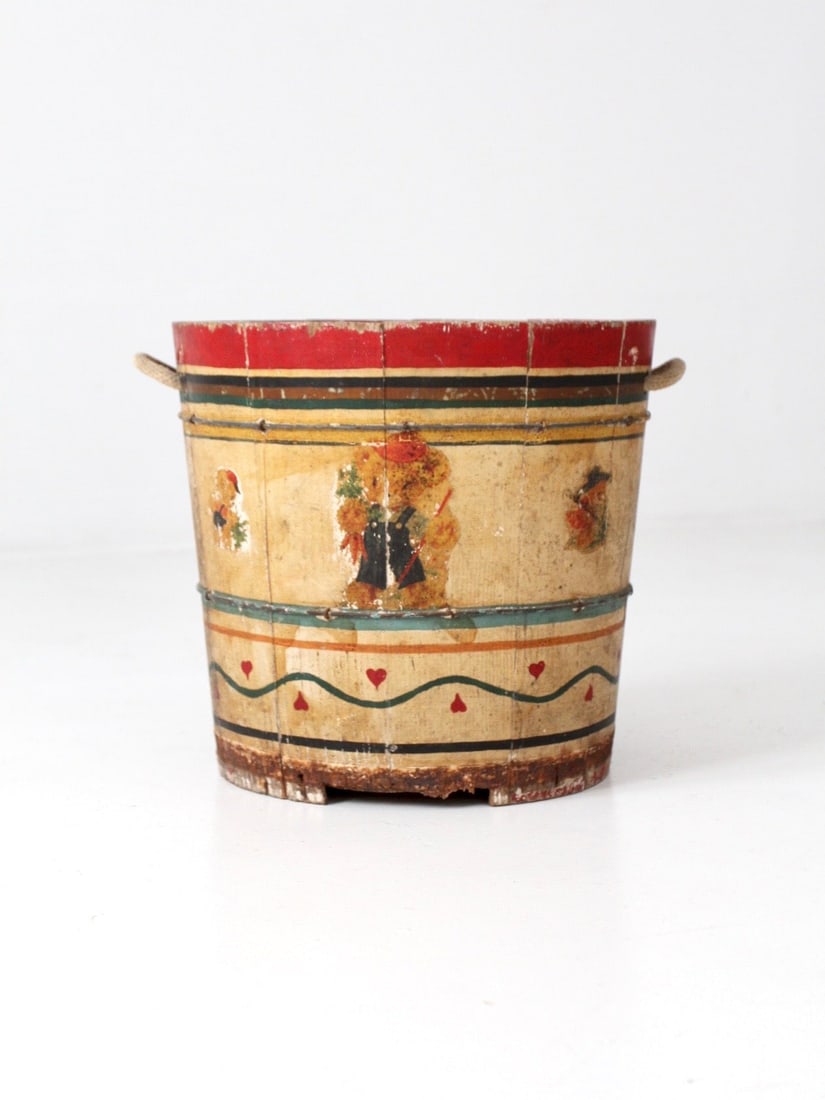 Vintage Folk Art Painted Wooden Bucket with Heart and Teddy Bear Design: Vintage Folk Art Painted Wooden Bucket with Heart and Teddy Bear Design This charming antique painted wooden bucket showcases a delightful folk art design. The vibrant yellow bucket is adorned with re