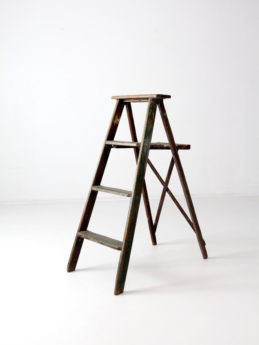 Rustic Vintage Green Wood Folding Ladder with Patina: Rustic Vintage Green Wood Folding Ladder with Patina This vintage wood folding ladder showcases an exquisitely aged green finish, enhanced by a unique patina and original hardware. The three-step desi