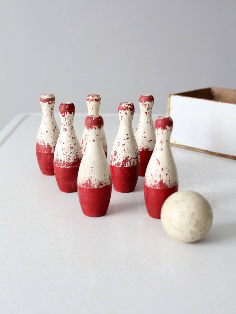 Antique Wooden Tabletop Bowling Game Set with Storage Box: Antique Wooden Tabletop Bowling Game Set with Storage Box This delightful antique tabletop bowling game set includes seven wooden pins, each elegantly painted white with charming red accents, along wi