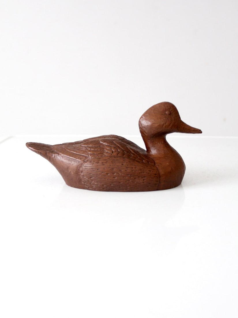 Vintage Red Mill Mfg Duck Decorative Accent 11 Inch Carved Wood Finish: Vintage Red Mill Mfg Duck Decorative Accent 11 Inch Carved Wood Finish This vintage Red Mill Mfg duck features a beautifully carved design that highlights intricate textures and a warm, wood-like fini