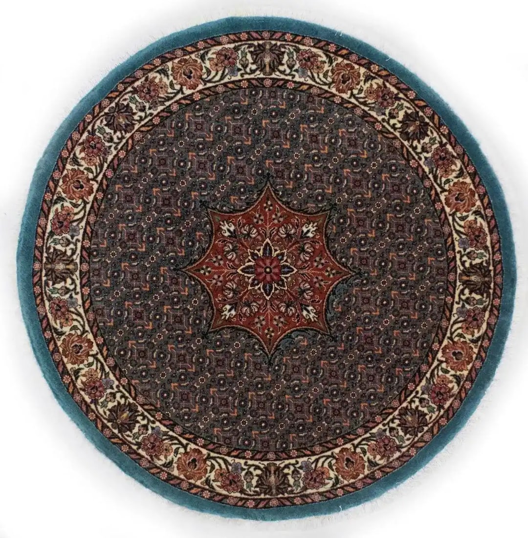 Round Hand-Knotted Wool Rug with Teal Floral Motif 44 Inch Diameter: Round Hand-Knotted Wool Rug with Teal Floral Motif 44 Inch Diameter This handmade round rug features a rare teal blue background with an intricate floral pattern and accents in rusty red, brown, pink,