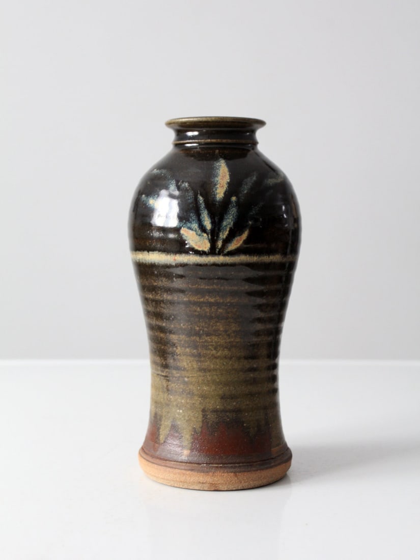 Vintage Studio Pottery Vase 10.5 Inch Brown Glaze Foliage Print: Vintage Studio Pottery Vase 10.5 Inch Brown Glaze Foliage Print This vintage studio pottery vase showcases a unique hand-crafted design, featuring a striking deep brown glaze complemented by a beautif