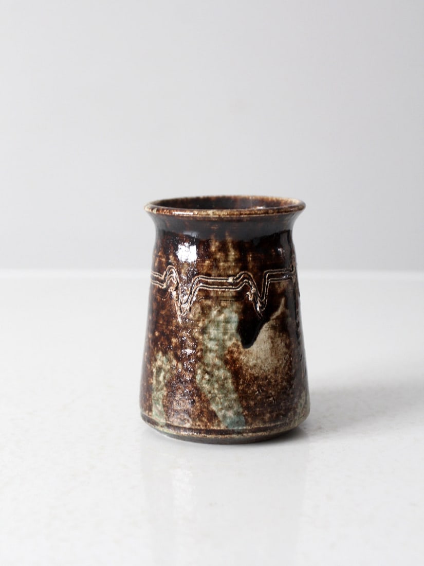 Handmade Vintage Studio Pottery Vase with Brown Glaze and Geometric Design: Handmade Vintage Studio Pottery Vase with Brown Glaze and Geometric Design This vintage studio pottery vase showcases a unique handmade conical shape, adorned with a rich brown sponged glaze and a han