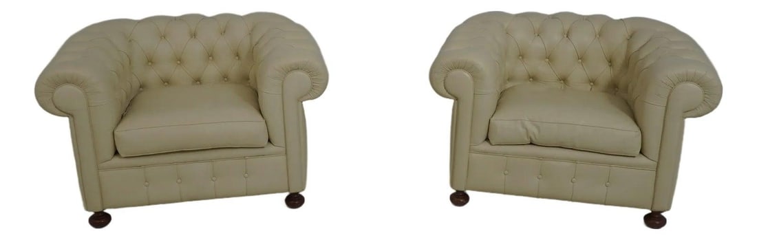 Set of Two Cream Leather Chesterfield Armchairs with Cherry Turned Legs: Set of Two Cream Leather Chesterfield Armchairs with Cherry Turned Legs This is a pair of cream color leather Chesterfield chairs featuring classic English style with cherry turned legs and decorative