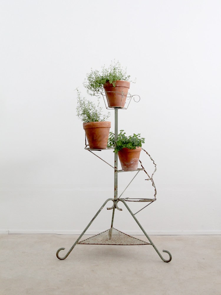 Vintage Mint Green Antique Plant Stand with 3 Platforms: Vintage Mint Green Antique Plant Stand with 3 Platforms This large antique plant stand showcases an intricate design with three wrap-around platforms that create a visually appealing display. The top
