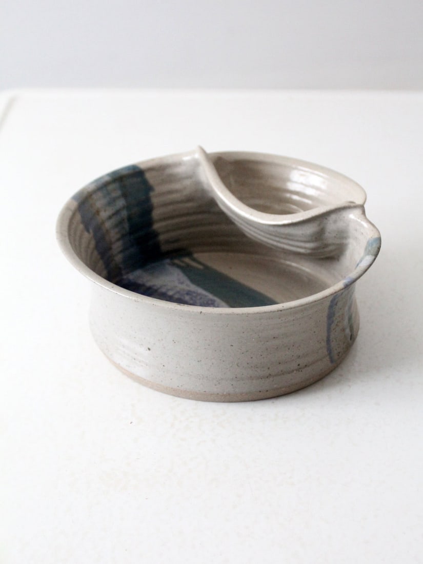 Signed Vintage Studio Pottery Bowl with Pocket and Blue Stripe Accents: Signed Vintage Studio Pottery Bowl with Pocket and Blue Stripe Accents This vintage studio pottery bowl showcases exquisite craftsmanship, featuring a unique design with a small pocket bowl incorporat