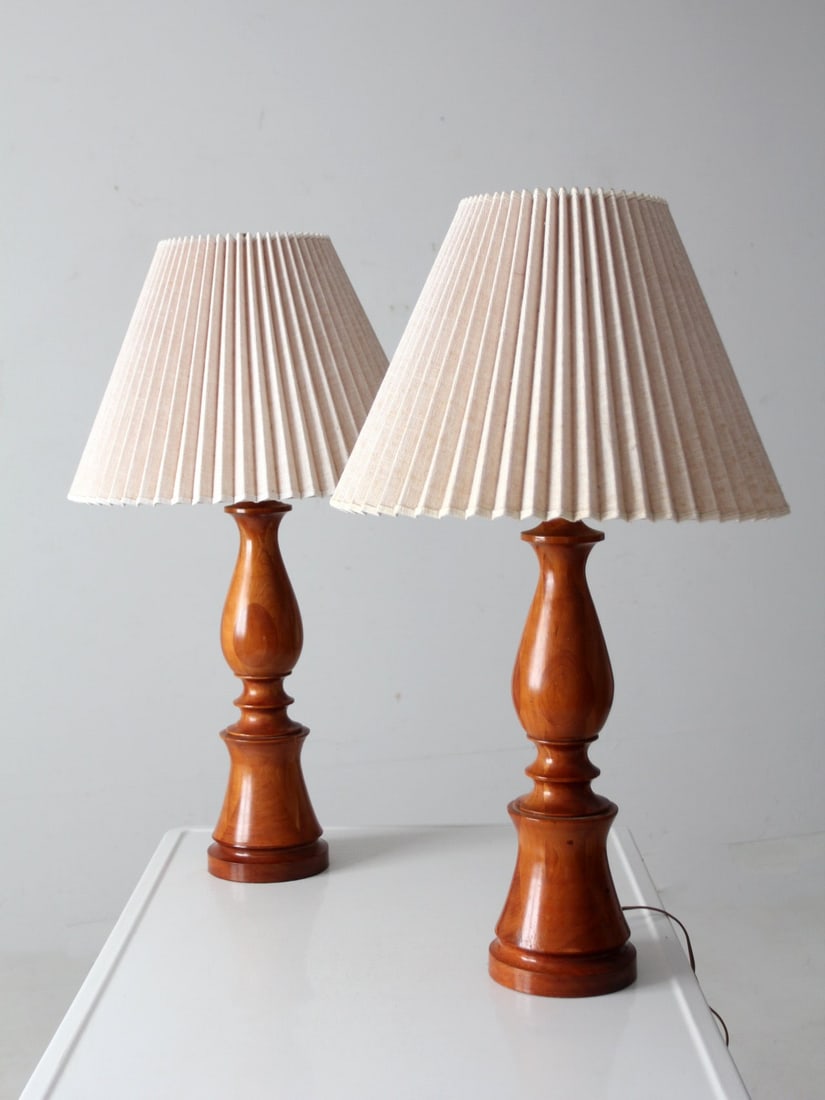 Vintage Turned Wood Table Lamps Pair with Linen Shades: Vintage Turned Wood Table Lamps Pair with Linen Shades Enhance your living space with this elegant pair of vintage turned wood table lamps. Crafted with smooth sculptural bases in a polished honey ton
