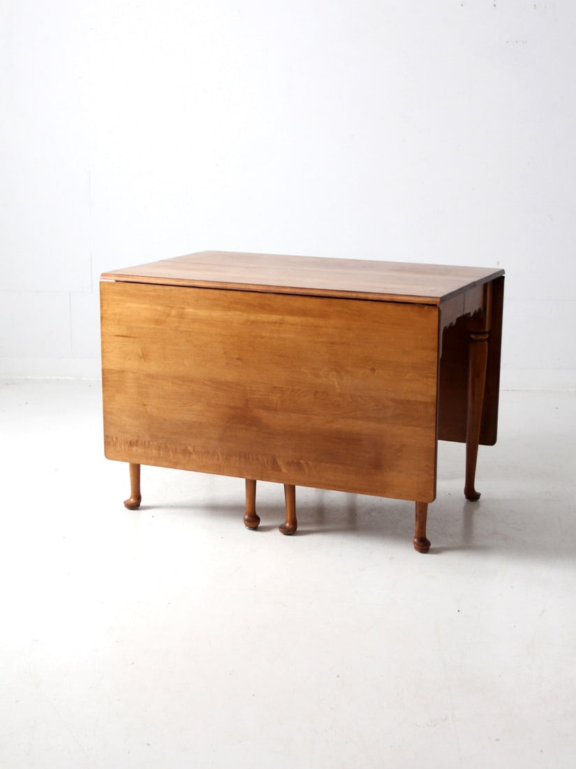 Vintage Honey Wood Antique Drop Leaf Gate Leg Table: Vintage Honey Wood Antique Drop Leaf Gate Leg Table This antique wood drop-leaf table beautifully combines space-saving functionality with an elegant design. Featuring hinged drop leaves and a traditi