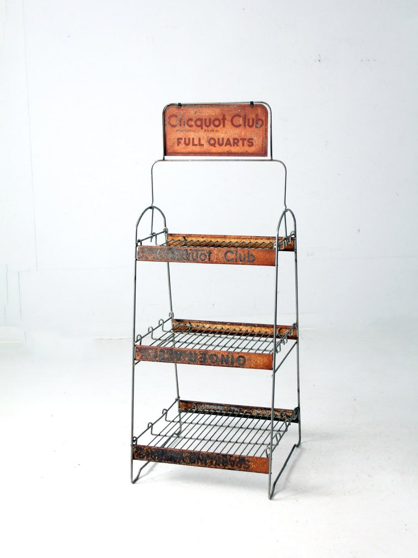 Antique Cliquot Club Wire Soda Bottle Display Rack: Antique Cliquot Club Wire Soda Bottle Display Rack This early 20th-century Vintage Cliquot Club Display Rack is expertly crafted from wire metal and is designed specifically for showcasing Cliquot Clu
