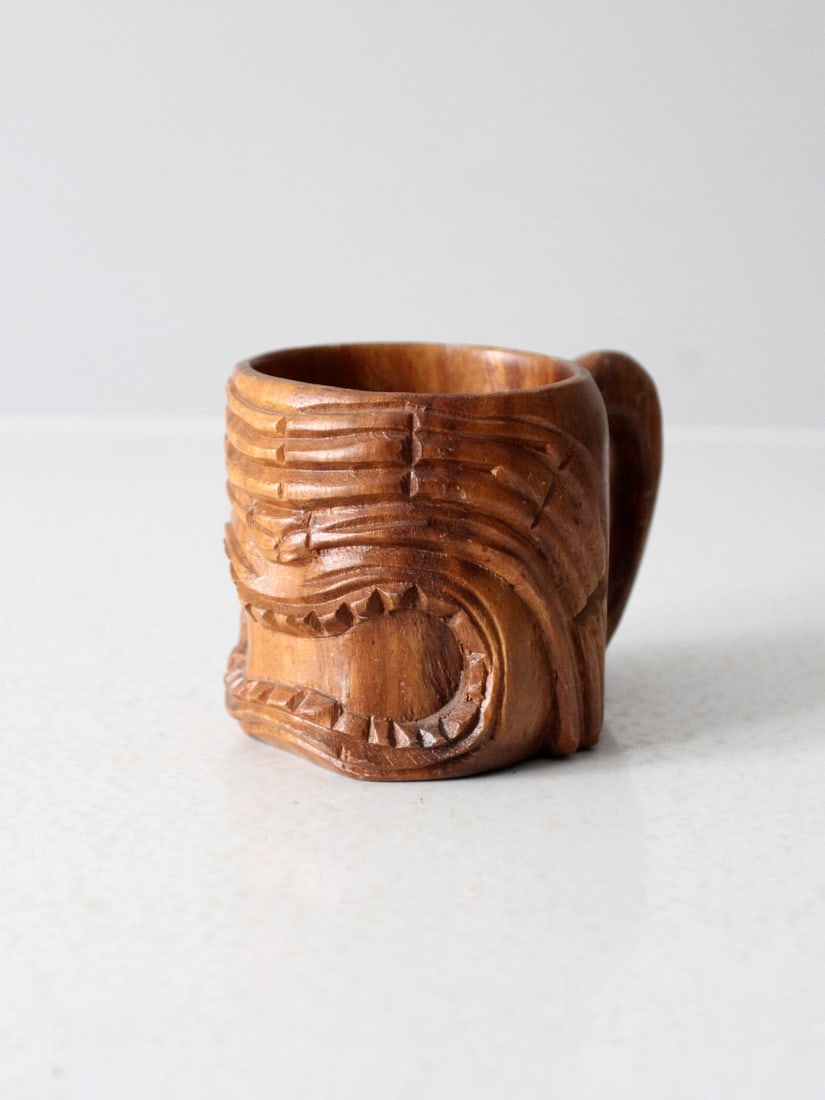 Vintage Hand-Carved Monkey Pod Tiki Mug Retro Island Decor: Vintage Hand-Carved Monkey Pod Tiki Mug Retro Island Decor Elevate your home or bar decor with this Vintage Monkey Pod Tiki Mug. Hand-carved from monkey pod wood, this unique piece showcases bold faci