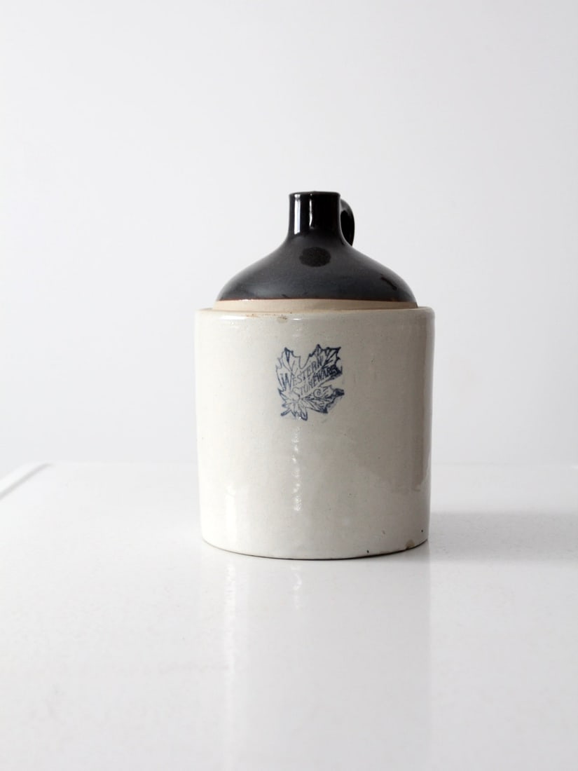Antique Western Stoneware Jug 10.5 Inch with Blue Leaf Logo: Antique Western Stoneware Jug 10.5 Inch with Blue Leaf Logo This antique Western Stoneware crock jug is a remarkable example of American stoneware craftsmanship. It features a dark brown slip top pair