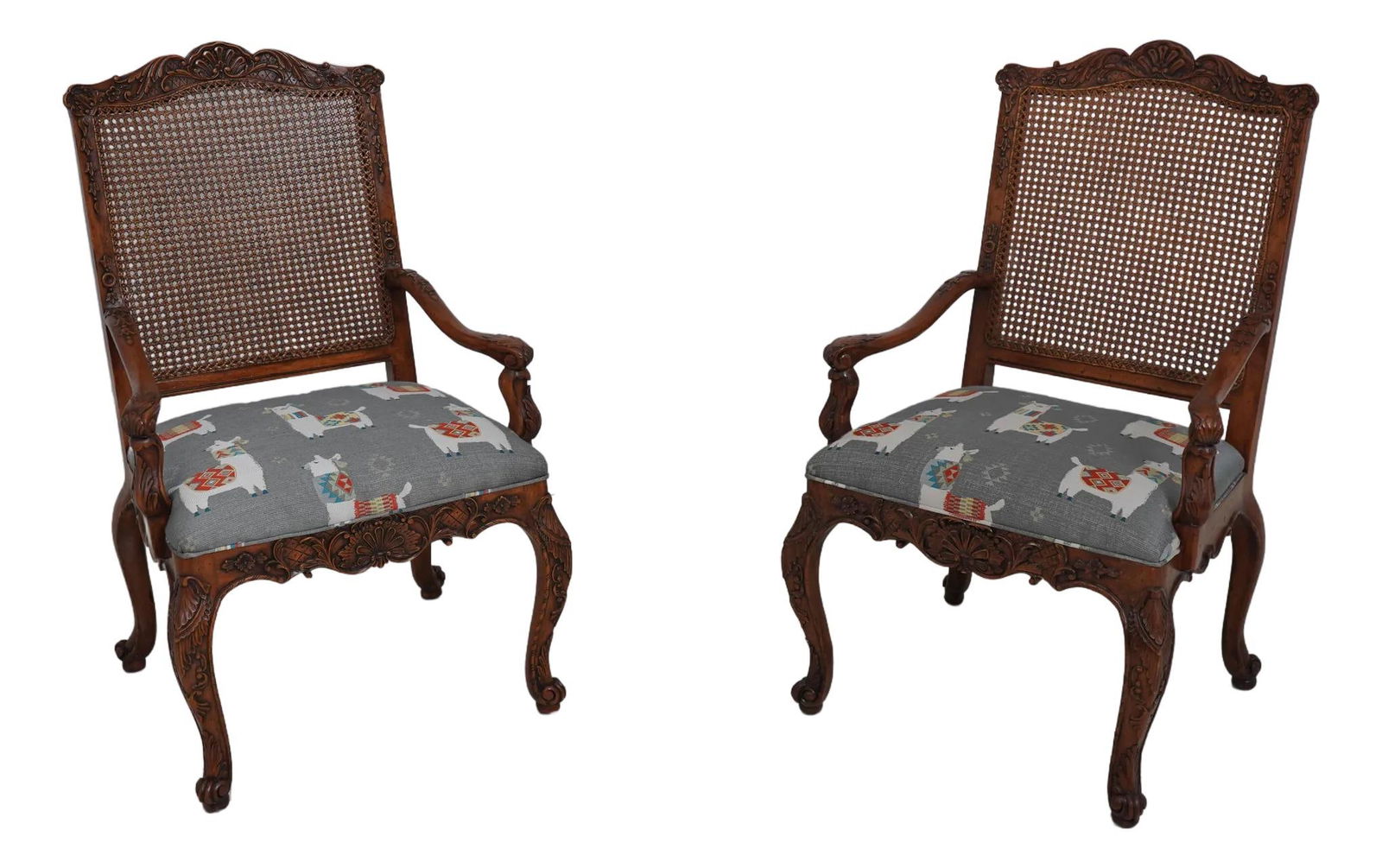 Pair of French Louis XV Cane Back Armchairs Walnut Upholstered Llama Fabric: Pair of French Louis XV Cane Back Armchairs Walnut Upholstered Llama Fabric This exquisite pair of French Louis XV cane back open fauteuil armchairs showcases exceptional craftsmanship and timeless de
