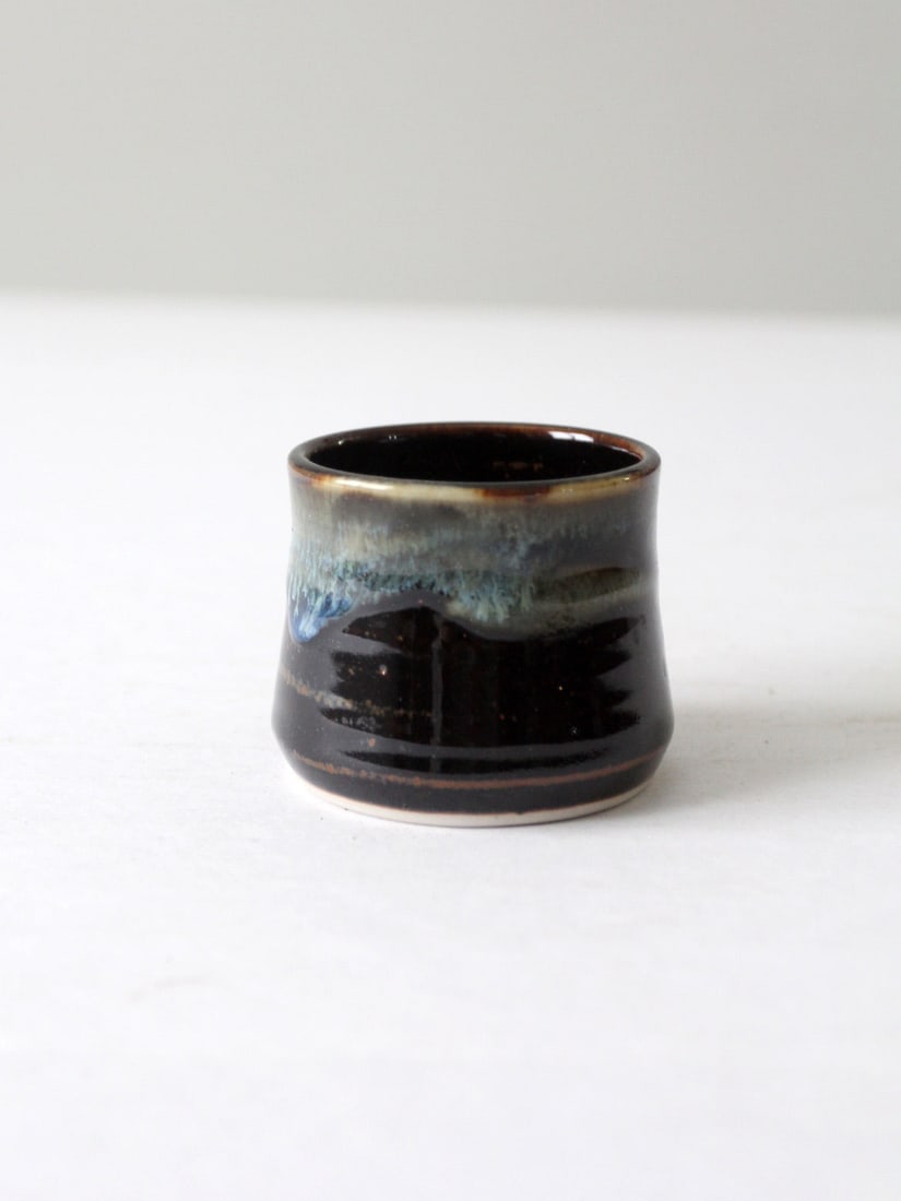 Vintage Studio Pottery Vase with Layered Glaze Finish: Vintage Studio Pottery Vase with Layered Glaze Finish This vintage studio pottery vase features a stunning layered glaze that seamlessly blends deep espresso brown with rich blue and moss tones, resem