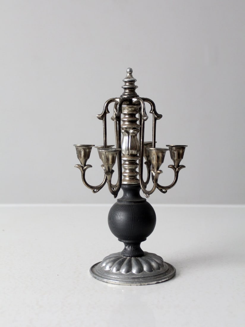 Mid-Century Vintage Silver Plate and Wood Candelabra: Mid-Century Vintage Silver Plate and Wood Candelabra This charming vintage piano candelabra, dating back to the mid 20th century, features an ornate silver-plate finish complemented by a sleek black w