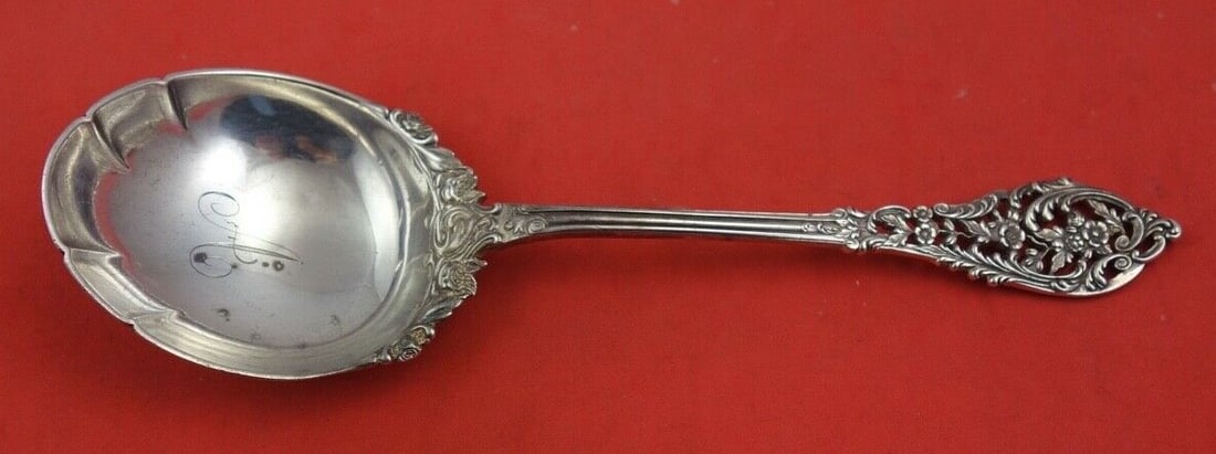 Dominick & Haff Trianon Sterling Silver Berry Spoon 8 1/4": Dominick & Haff Trianon Sterling Silver Berry Spoon 8 1/4" This exquisite sterling silver berry spoon, crafted by Dominick & Haff, features the elegant Trianon Pierced pattern, adorned with delicate f