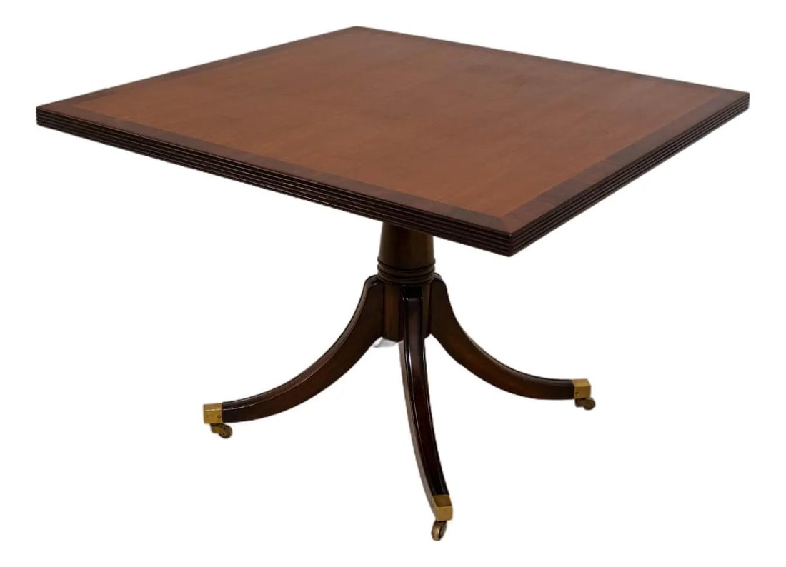 Square Mahogany Breakfast Table with Duncan Phyfe Pedestal Base Circa 1950s: Square Mahogany Breakfast Table with Duncan Phyfe Pedestal Base Circa 1950s This vintage English square breakfast table features a classic Duncan Phyfe pedestal base and showcases high-quality constru