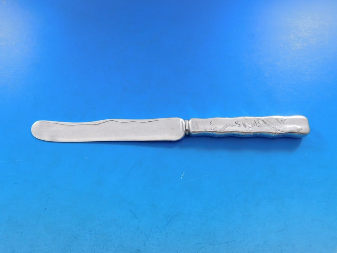 Tiffany & Co Lap Over Edge Acid Etched Sterling Silver Dessert Knife 7 1/4": Tiffany & Co Lap Over Edge Acid Etched Sterling Silver Dessert Knife 7 1/4" This exquisite dessert knife features a lap over edge design and is acid etched with lizards, crafted by Tiffany & Co. Made
