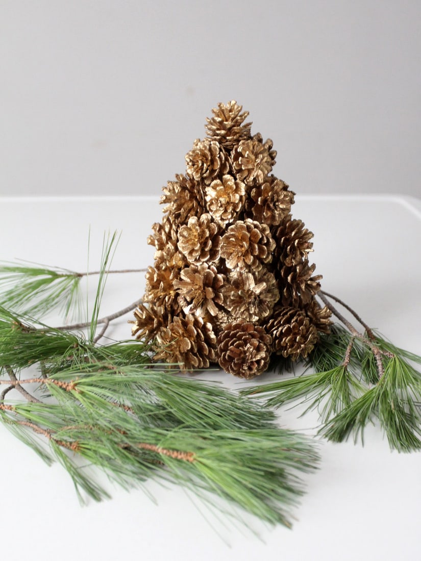 Vintage Gold Pinecone Decorative Accent 7 x 8.5 Inches: Vintage Gold Pinecone Decorative Accent 7 x 8.5 Inches This vintage gold pinecone tree exudes a warm, understated glow, perfect for seasonal decorating. Crafted from an arrangement of pinecones in a c