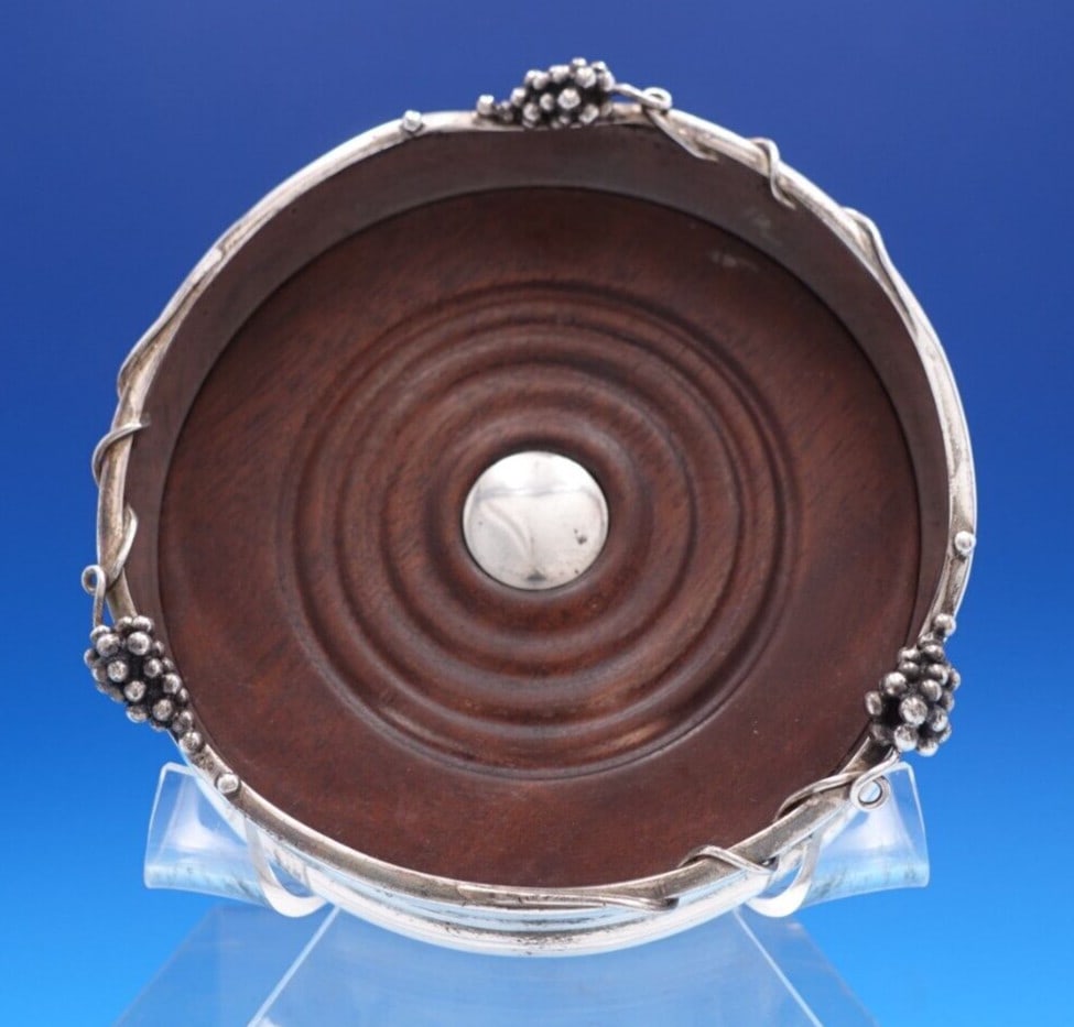 SJC Grape Pattern .925 Silver Wood Champagne Coaster 2 x 5: SJC Grape Pattern .925 Silver Wood Champagne Coaster 2 x 5 This exquisite champagne coaster features a delightful grape pattern, crafted from .950 sterling silver and wood. Measuring 2" x 5", it is de