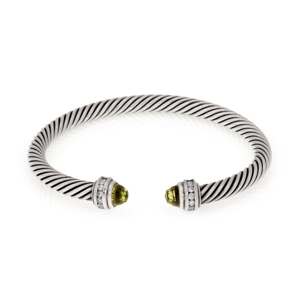David Yurman Sterling Silver Cable Cuff Bracelet with Diamonds and Green Gemstones: David Yurman Sterling Silver Cable Cuff Bracelet with Diamonds and Green Gemstones Elevate your accessory collection with this exquisite cuff bracelet by David Yurman. Crafted from high-quality sterli
