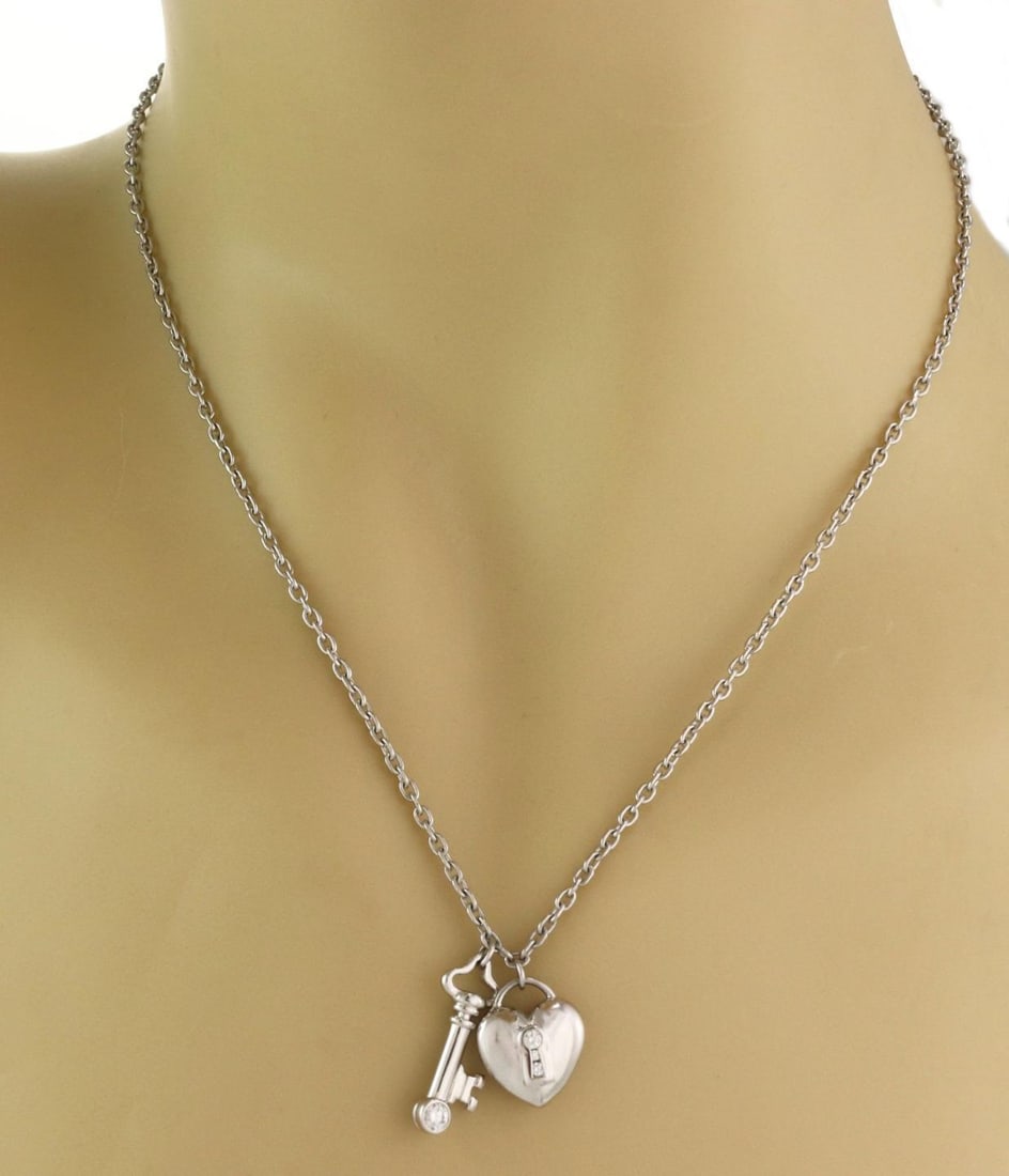 Tiffany & Co. Platinum Heart Padlock Necklace with Diamonds: Tiffany & Co. Platinum Heart Padlock Necklace with Diamonds Enhance your jewelry collection with this exquisite Tiffany & Co. Padlock & Key Necklace. Crafted in luxurious platinum, it features a heart