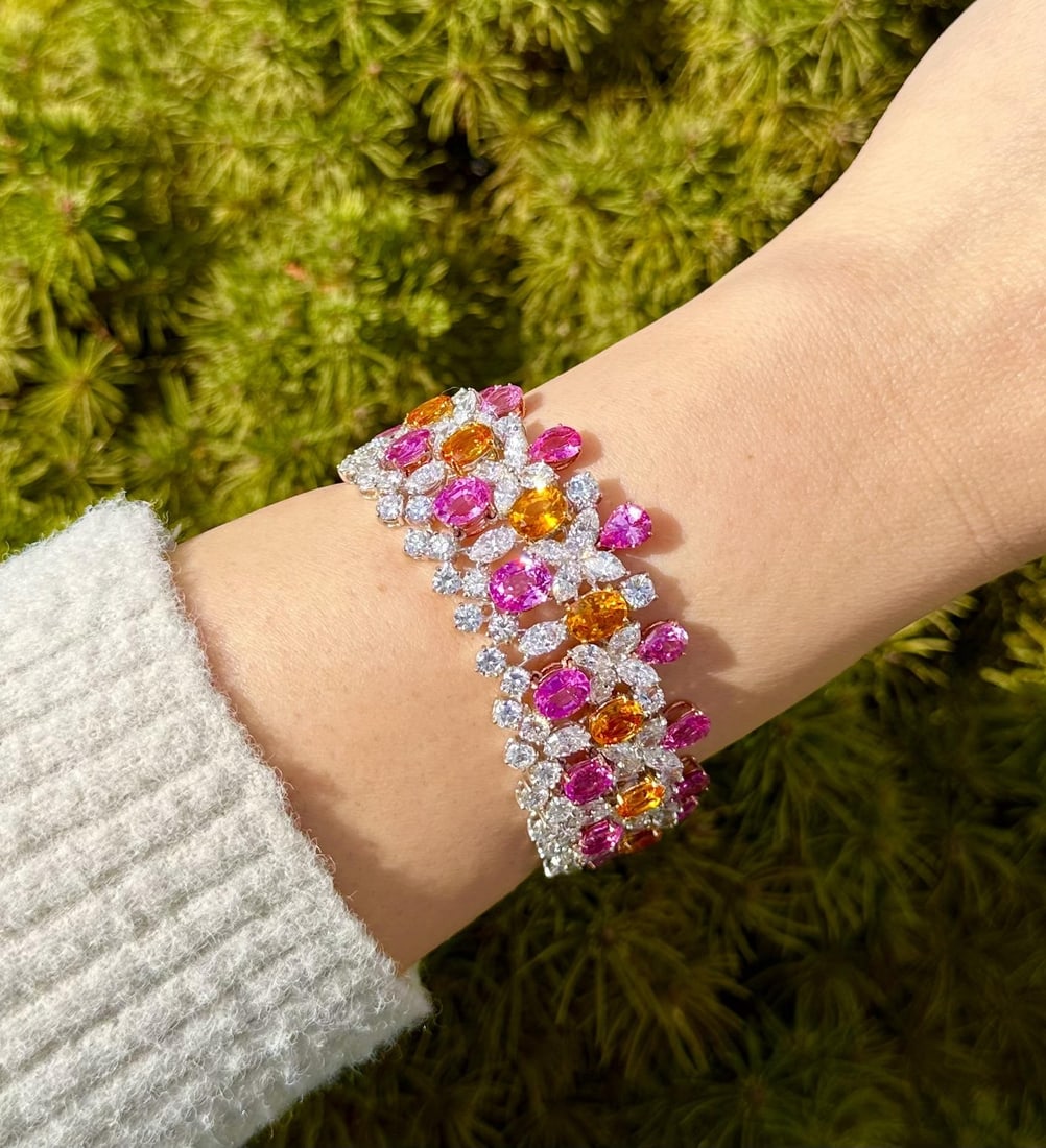 GIA Certified 64.12ctw Pink Orange Sapphire Diamond Bracelet in Platinum Gold: GIA Certified 64.12ctw Pink Orange Sapphire Diamond Bracelet in Platinum Gold This stunning statement bracelet features a luxurious combination of natural pink and orange sapphires alongside brilliant