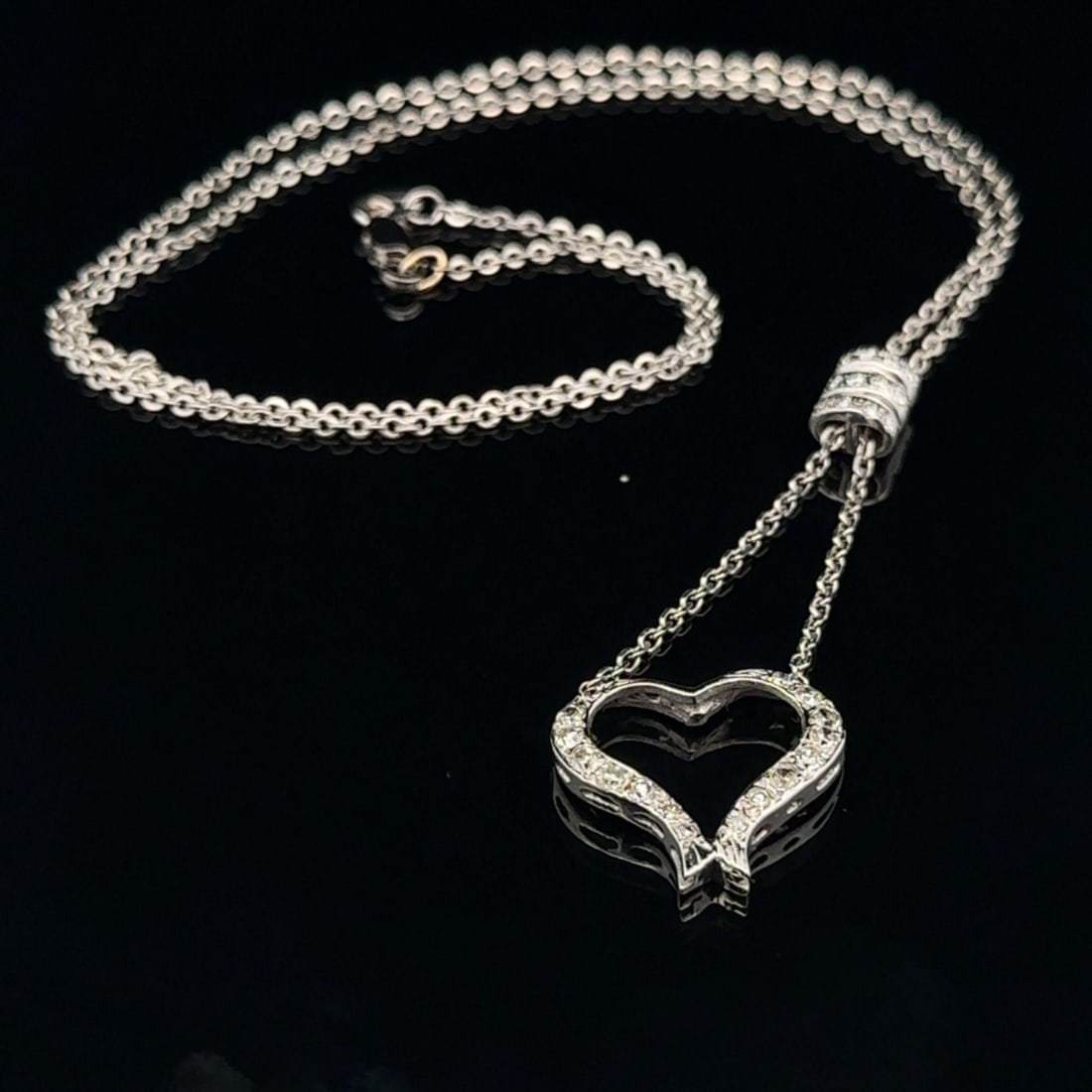 14k White Gold Diamond Dangle Heart Pendant Necklace 0.50ctw: 14k White Gold Diamond Dangle Heart Pendant Necklace 0.50ctw This exquisite pendant necklace features a stunning open heart design crafted from solid 14k white gold. Adorned with 28 natural genuine di