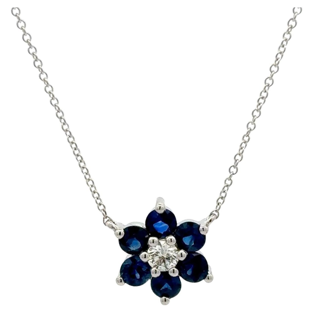 Floral Cluster Necklace with Diamond and Sapphires in 14K White Gold: Floral Cluster Necklace with Diamond and Sapphires in 14K White Gold This contemporary cluster pendant necklace is crafted from 14 karat white gold and features a floral design. The pendant is set wit
