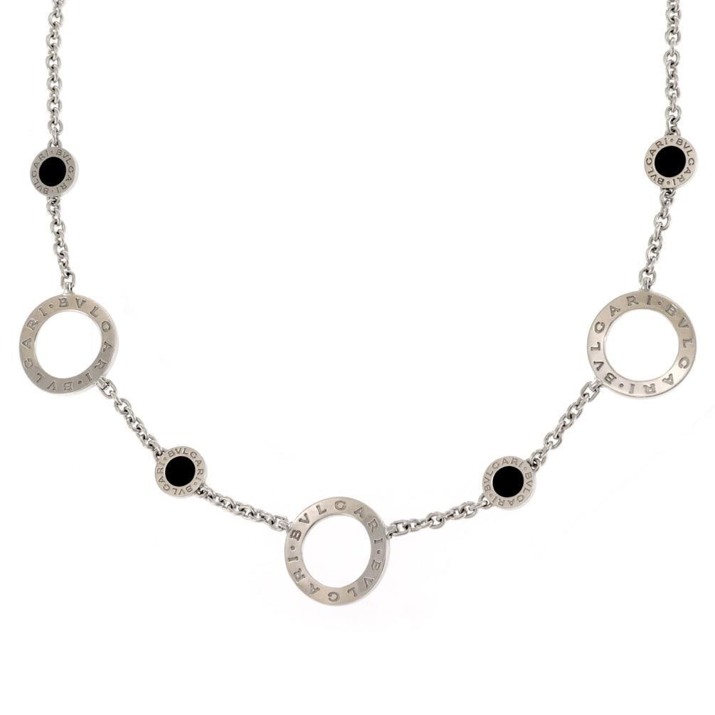 Bvlgari 18k White Gold Onyx Engraved Circle Motif Necklace: Bvlgari 18k White Gold Onyx Engraved Circle Motif Necklace This elegant necklace from Bvlgari's Signature Collection showcases a stunning design crafted from 18k white gold. It features small engraved
